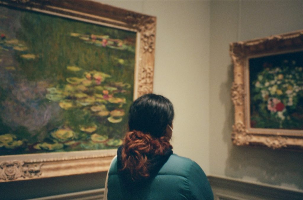 Hannah looking at some paintings in an art gallery