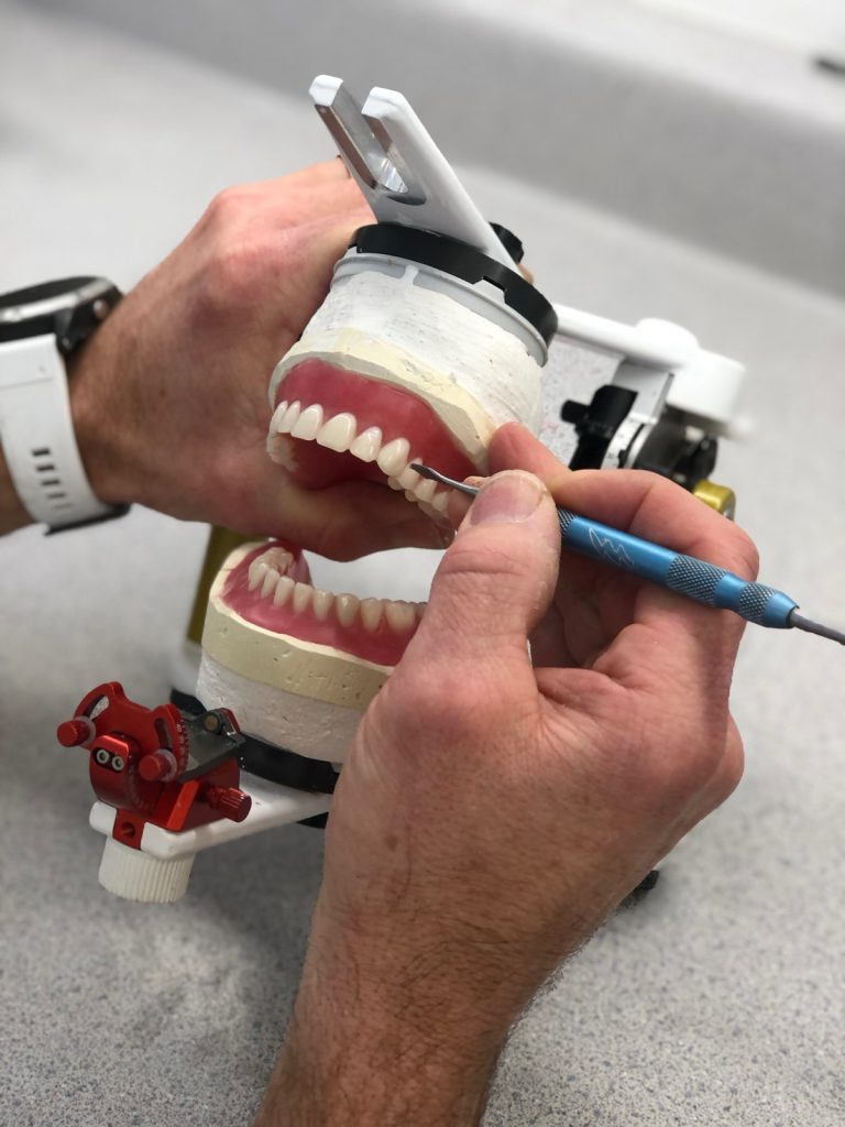 Working on a set of dentures