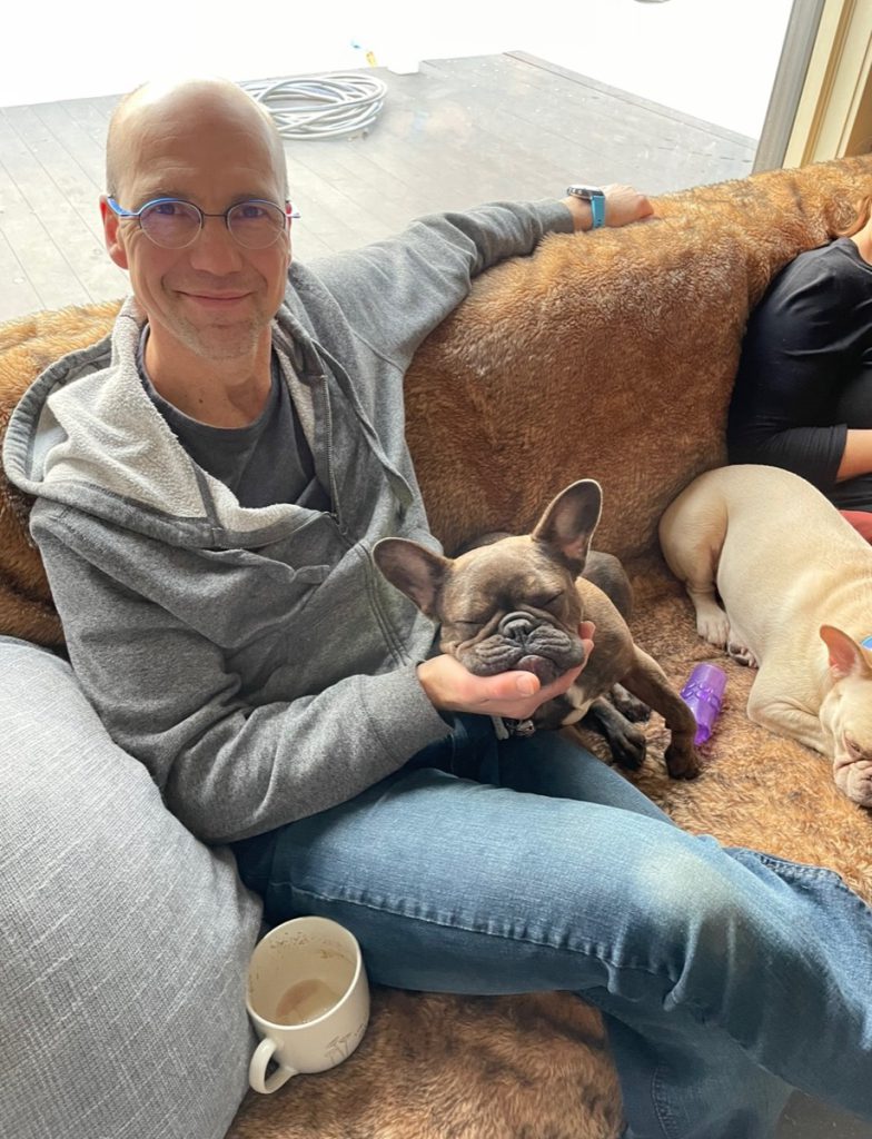 Michael Weiss sitting with his dog